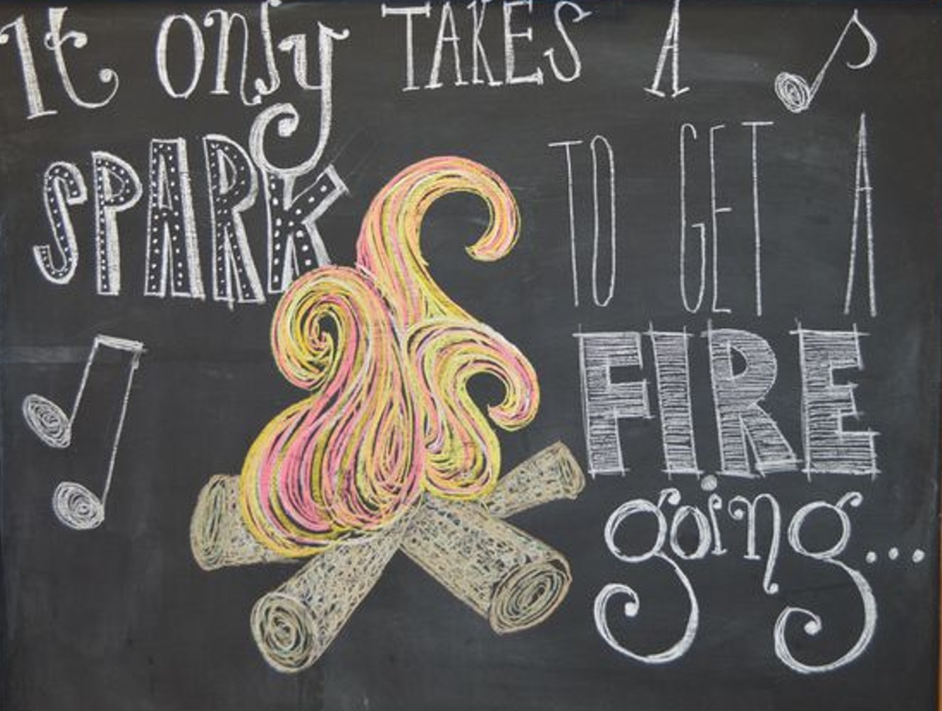 Chalkboard drawing: "It only takes a spark to get a fire going" with a campfire illustration.