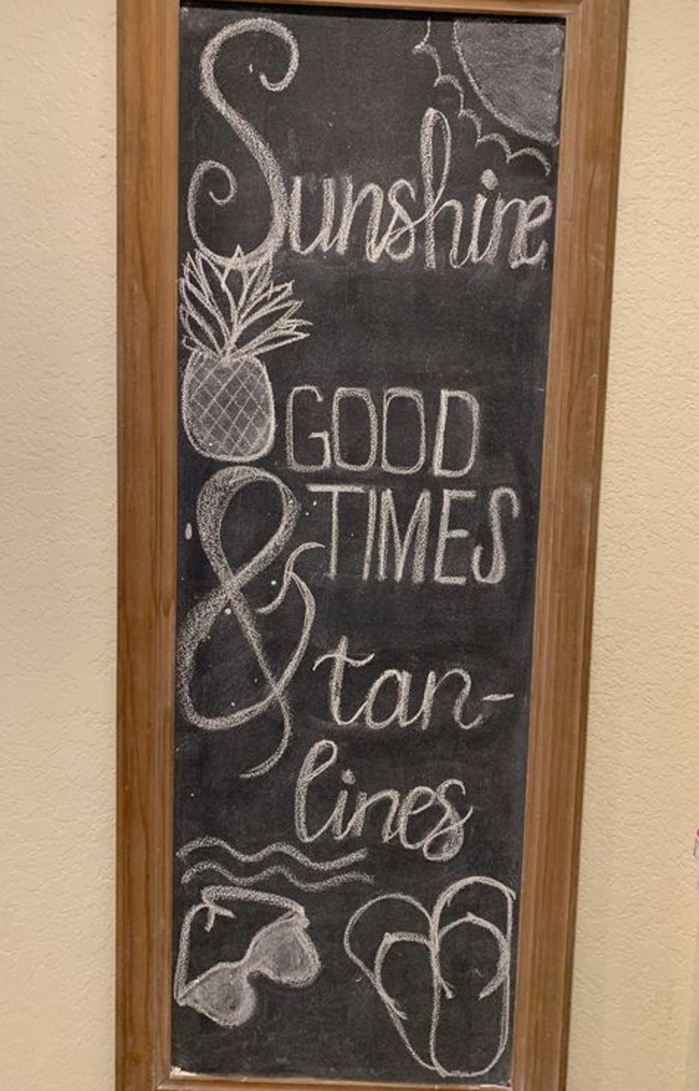 Chalkboard sign with "Sunshine, Good Times, & Tan Lines" and summer doodles.