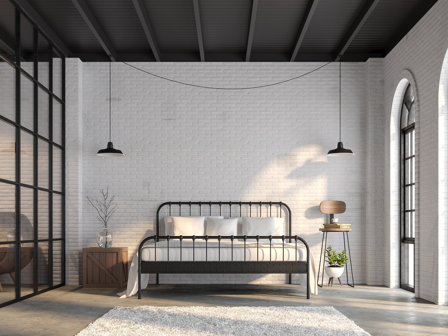 Loft bedroom featuring a black metal bed frame, white brick walls, and industrial lighting