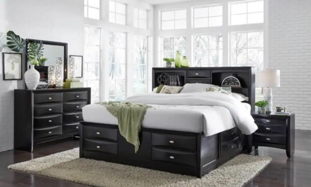 Modern bedroom with dark wood furniture, storage bed, large windows, and green decor accents.