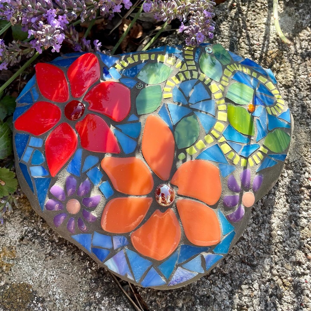 Colorful mosaic rock with vibrant flower patterns on stone surface