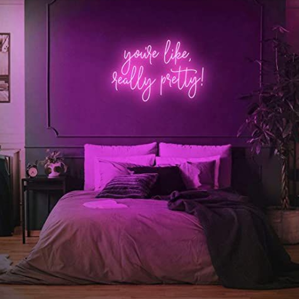 Bedroom with neon sign above bed