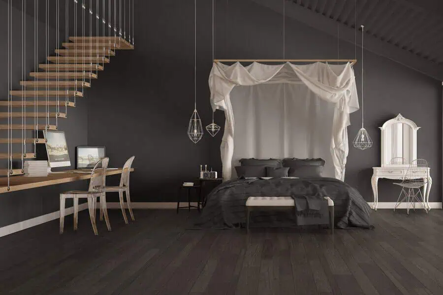 Chic bedroom with dark walls, a canopy bed, floating staircase, and minimalist decor.