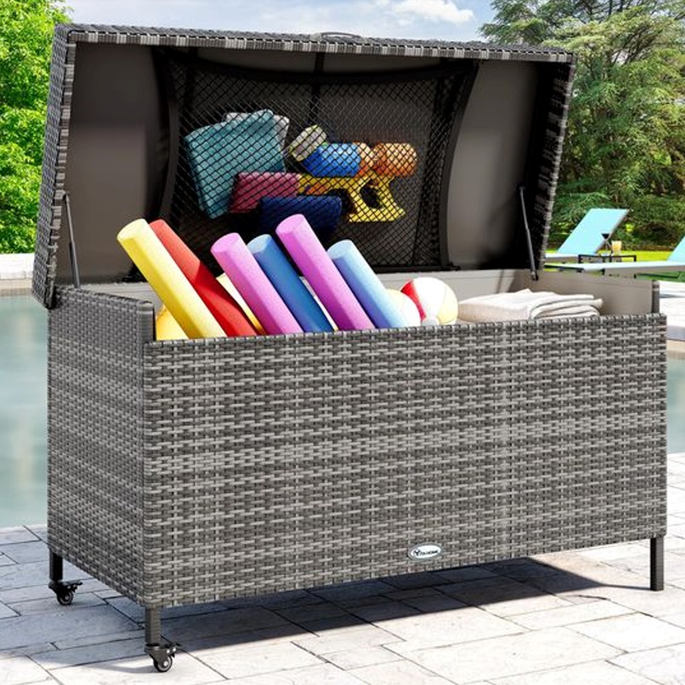 Open outdoor storage box filled with colorful pool noodles and toys.