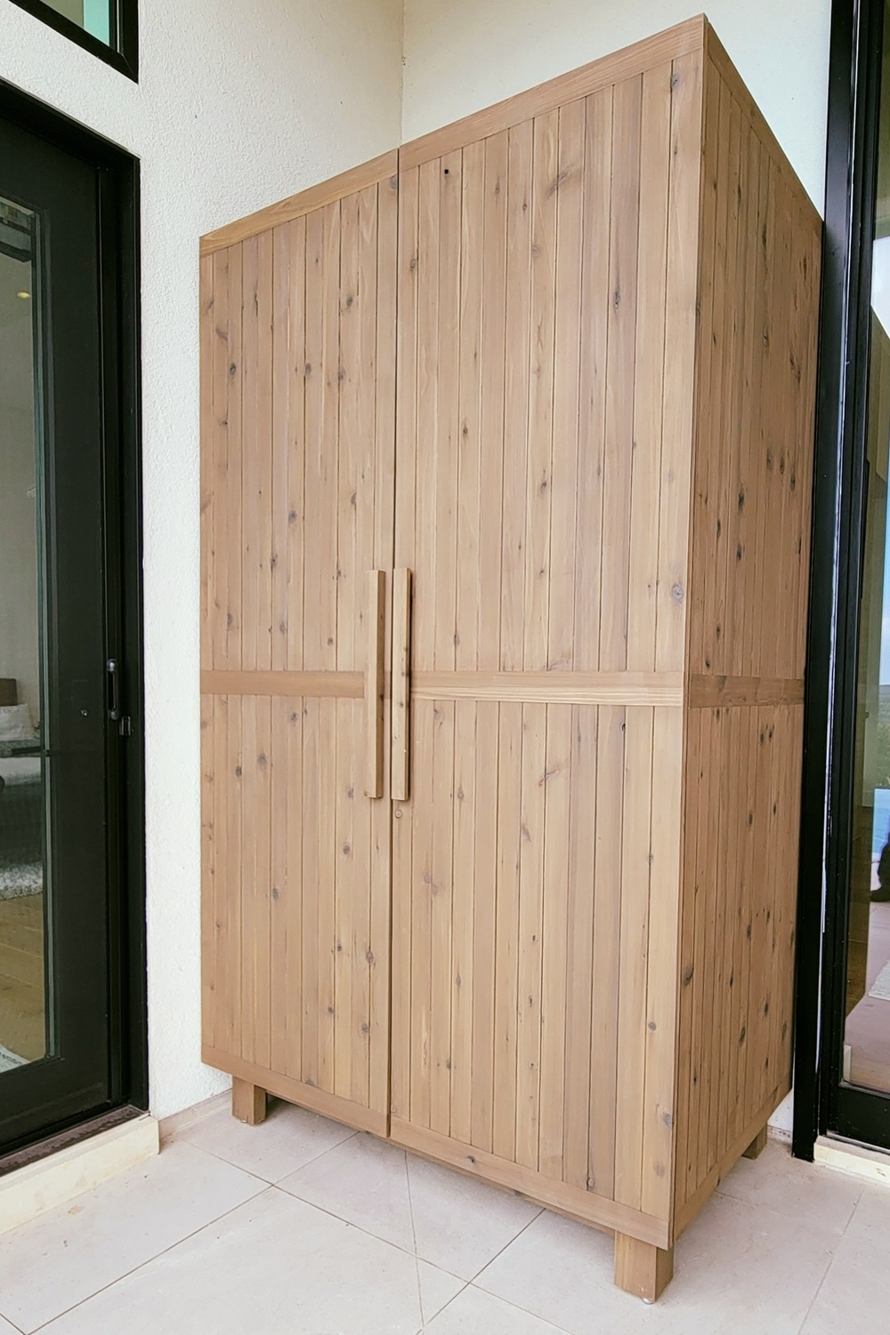 Tall wooden cabinet with double doors