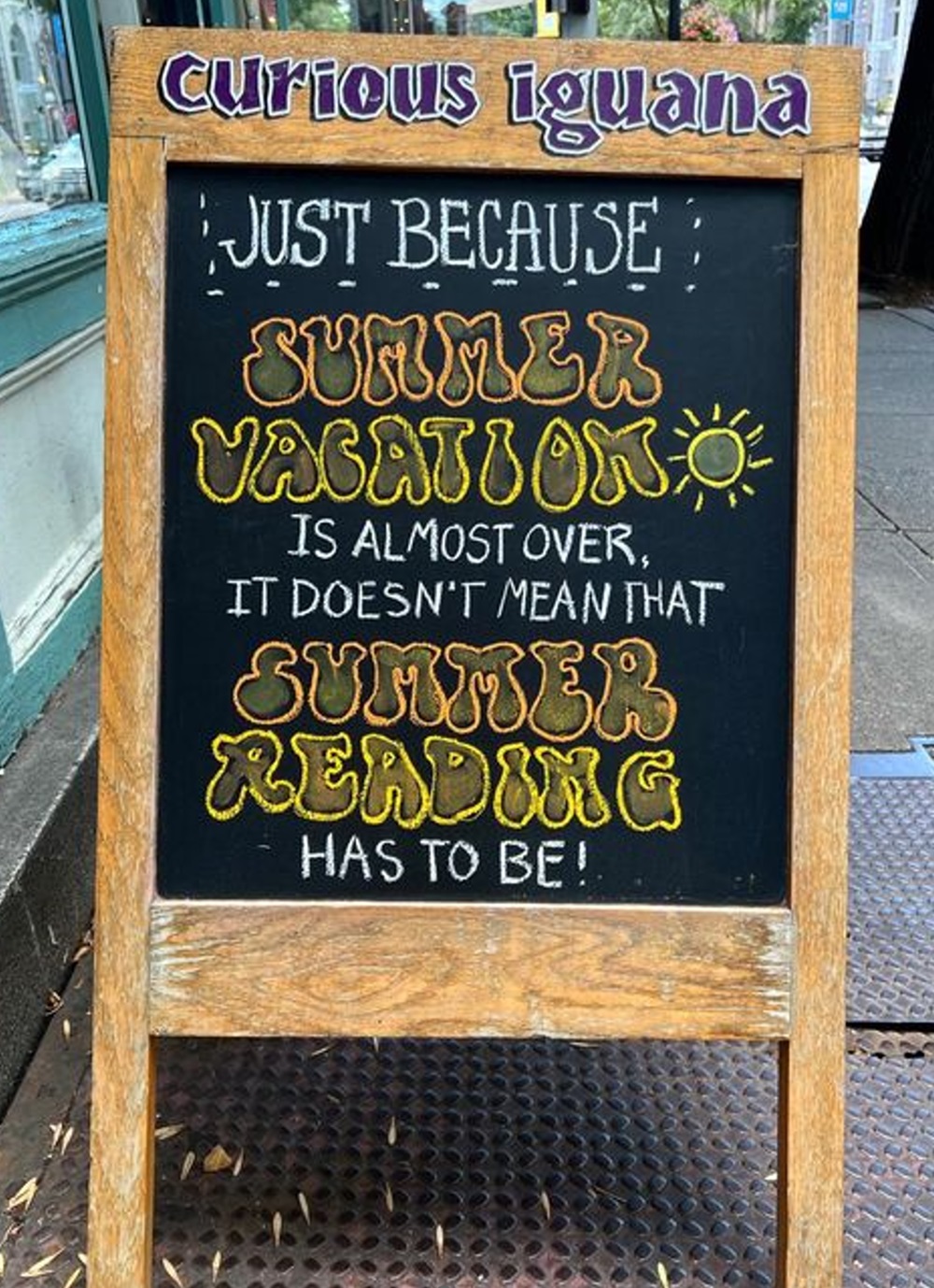 Chalkboard sign with "summer vacation" and "summer reading" brightly highlighted.