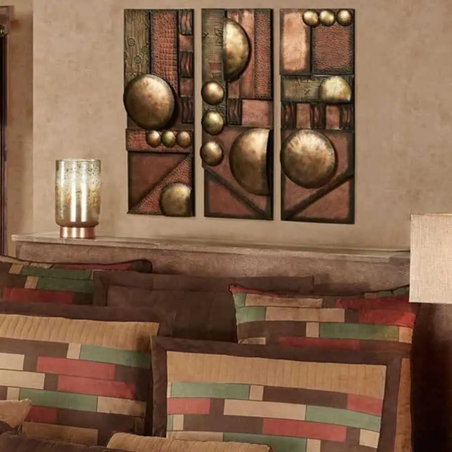 Colorful throw pillows and abstract wall art with spheres in a cozy, earth-toned room.