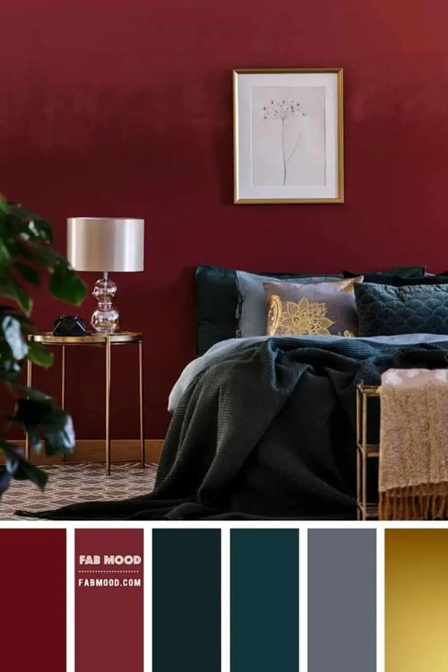 Cozy bedroom with a deep red wall, gold-accented decor, and a framed floral print above the bed.