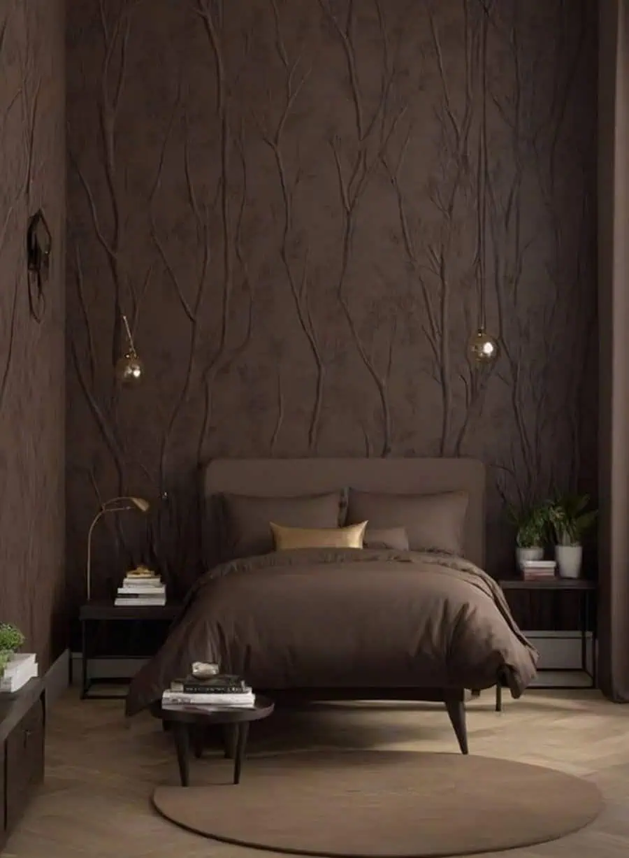 A cozy bedroom with brown decor, tree-patterned walls, and modern hanging lights.