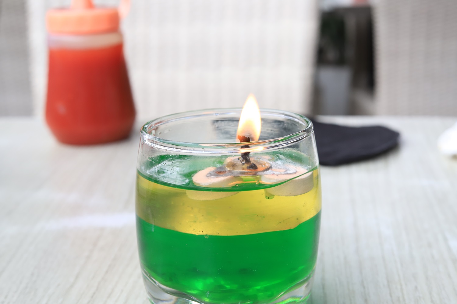 Fly Repellent Candle with green and yellow layers burning