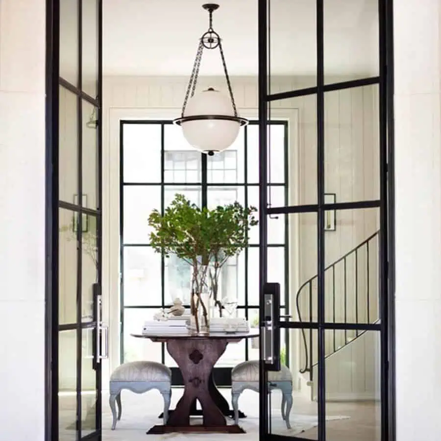 A modern dining nook with large glass doors and a spherical pendant light casting soft, ambient lighting.