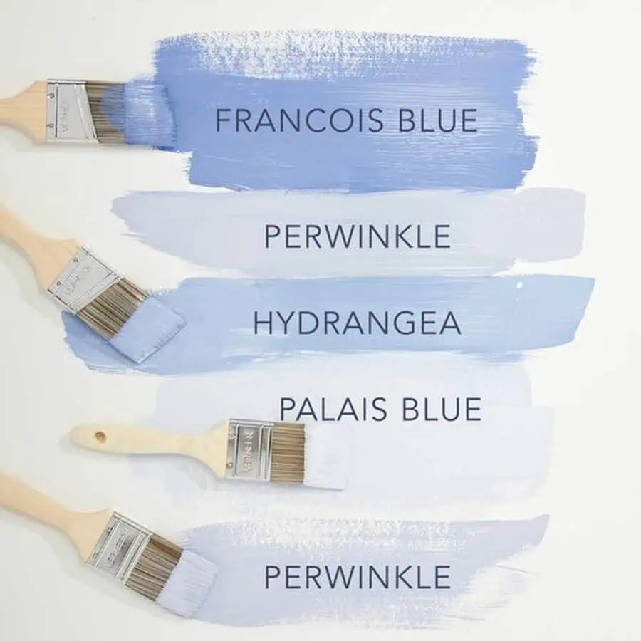 Paint swatches in different shades of blue with brushes