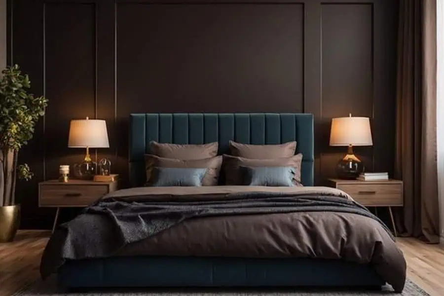 A cozy bedroom with a dark feature wall, a bed with teal headboard, and two bedside tables with lamps.