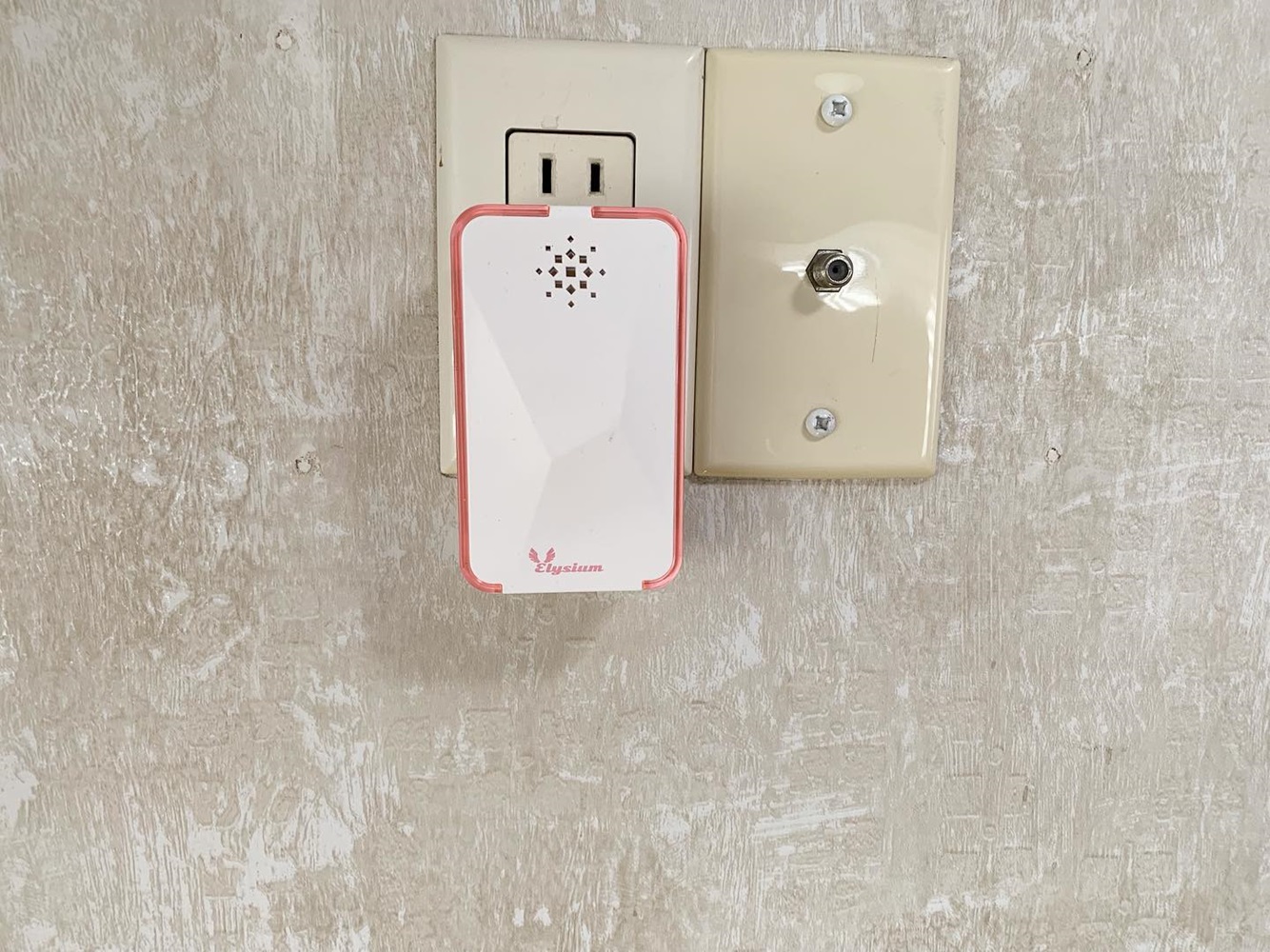 White Ultrasonic Pest Repeller connected to a wall outlet