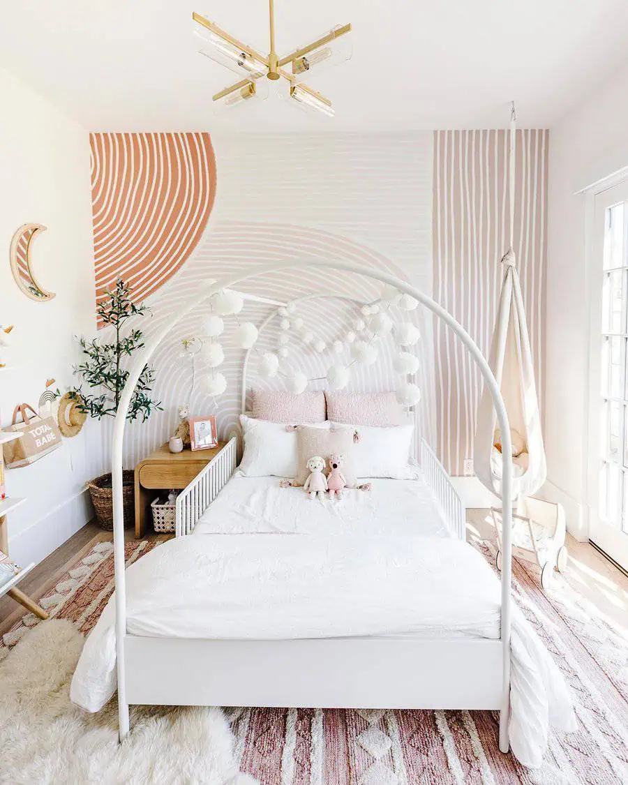 Bright and playful child's bedroom with a white canopy bed, pastel wall art, and whimsical decor.