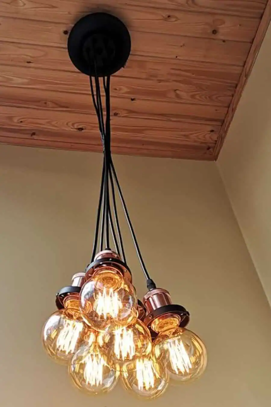 A cluster of vintage-style Edison bulbs hangs from the ceiling, emitting warm light