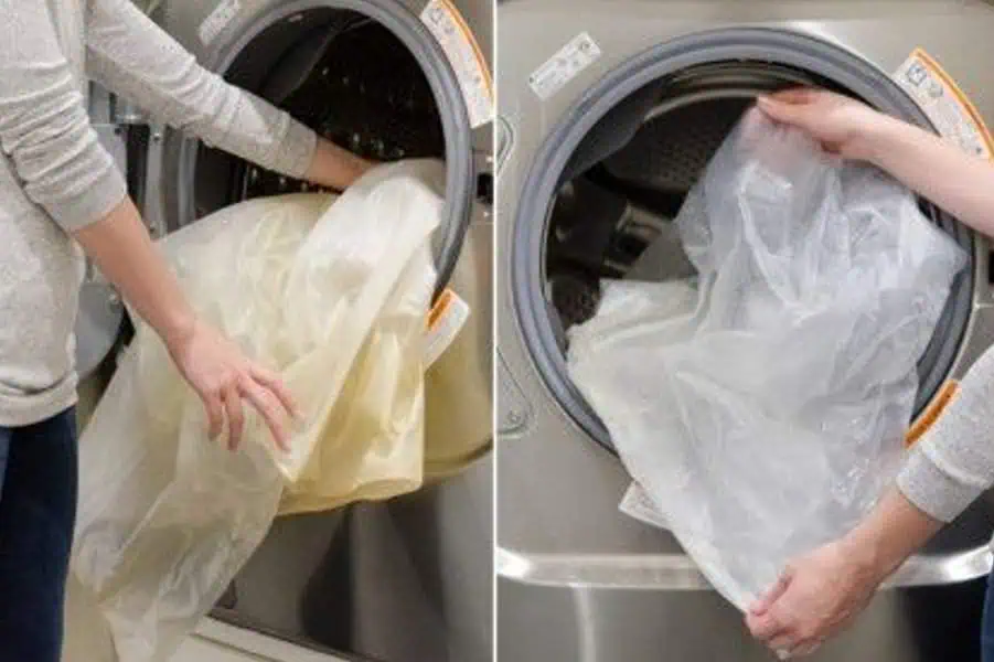 Individual handling a shower curtain liner by the washing machine