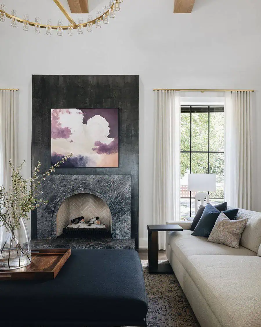 Modern fireplace with a dramatic accent wall, stylish artwork, and elegant decor accents.