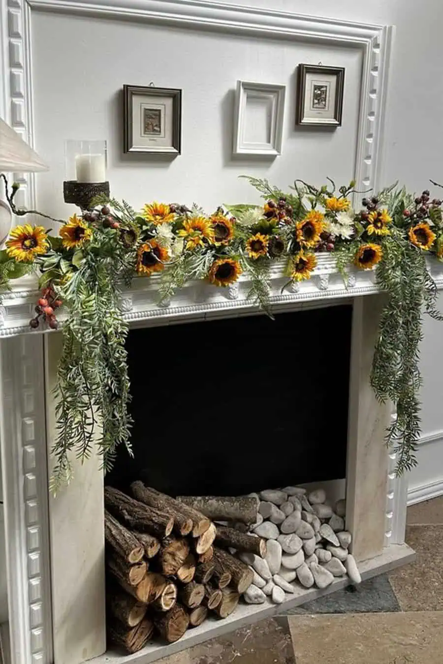 Cheerful mantel decor featuring sunflowers, greenery, and neatly stacked logs with decorative stones.