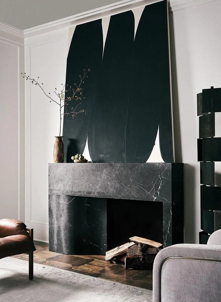 Elegant modern fireplace with a sleek marble mantel, abstract wall art, and stylish decor accents.