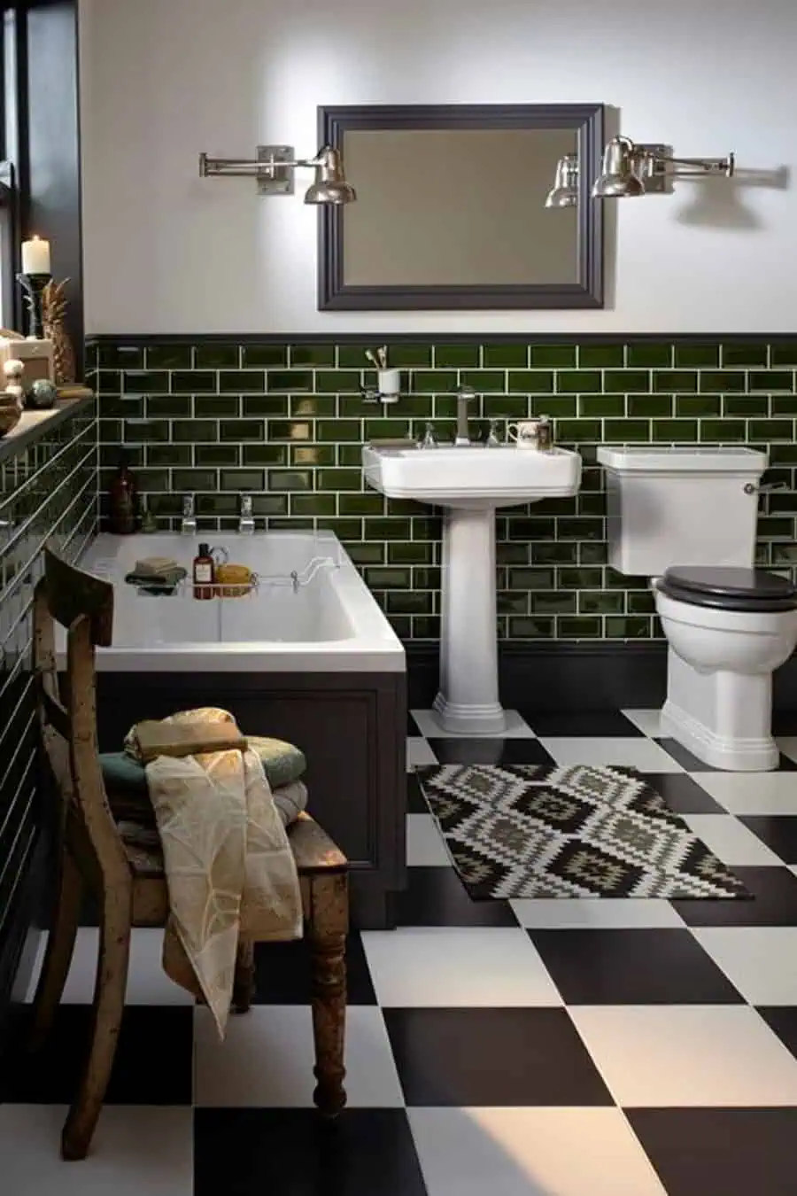 Art Deco bathroom with green subway tiles, pedestal sink, black and white checkered floor, and bathtub.