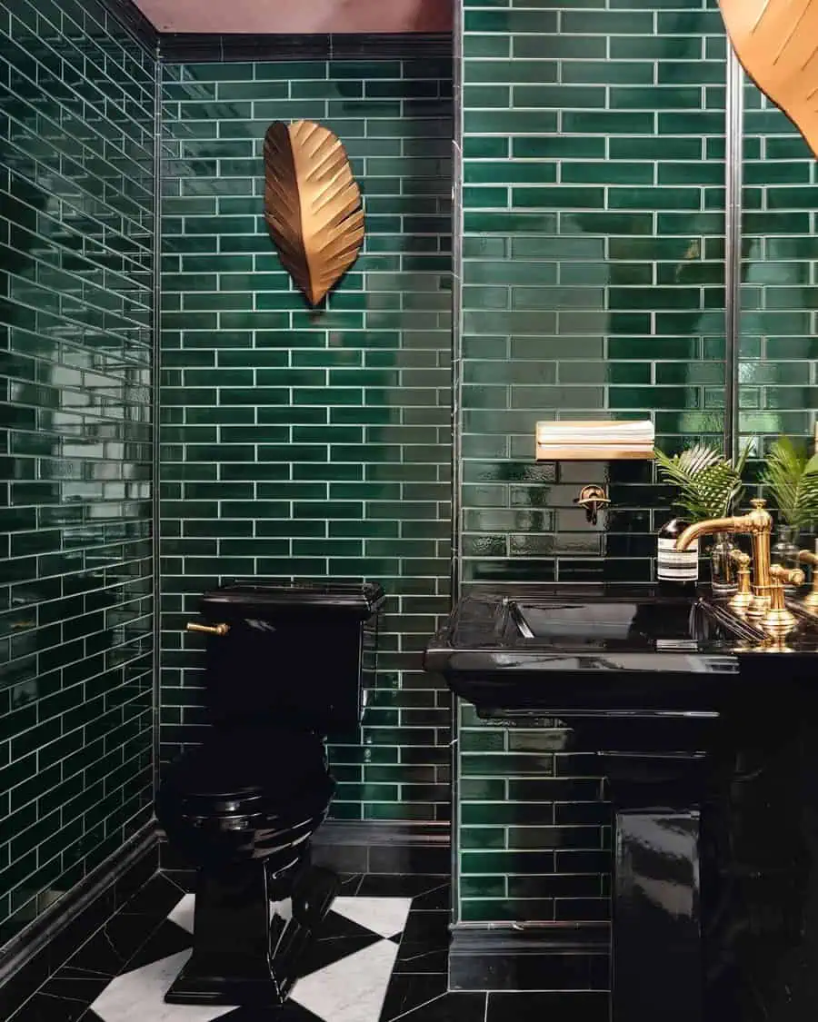 Green tiled Art Deco bathroom with black fixtures, gold accents, and geometric floor design.