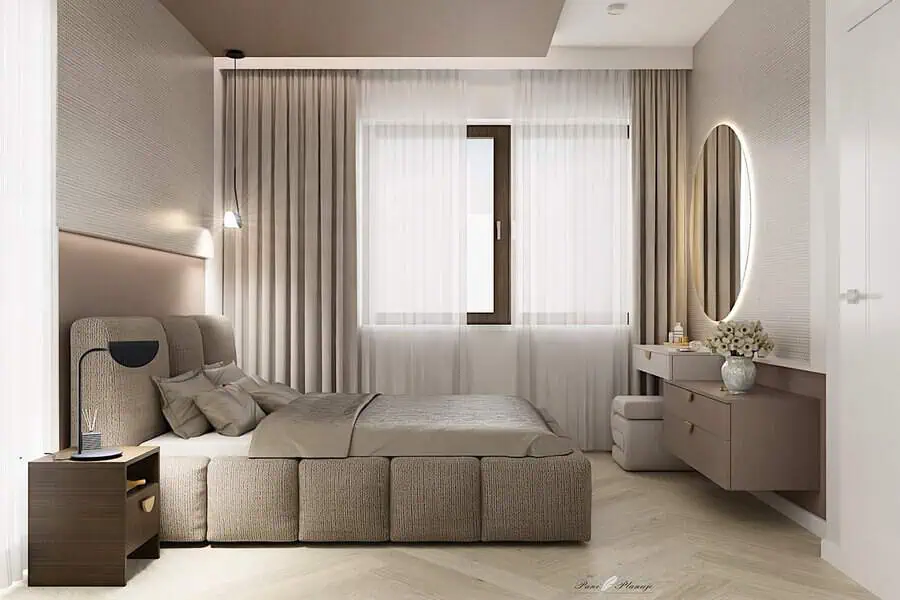 Modern bedroom with neutral tones, upholstered bed, and round illuminated mirror.