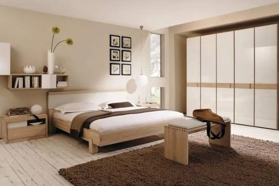 Contemporary bedroom with neutral tones, wooden furniture, and a large wardrobe with sliding doors.