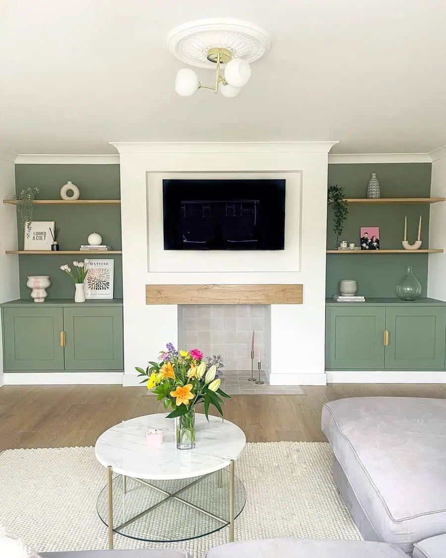 Fresh living room with sage green built-ins, a marble coffee table, and a floral centerpiece.