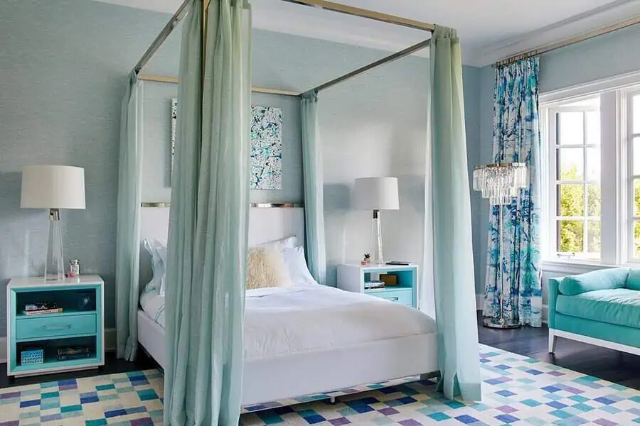 Vibrant bedroom with a four-poster bed, teal accents, and patterned curtains.