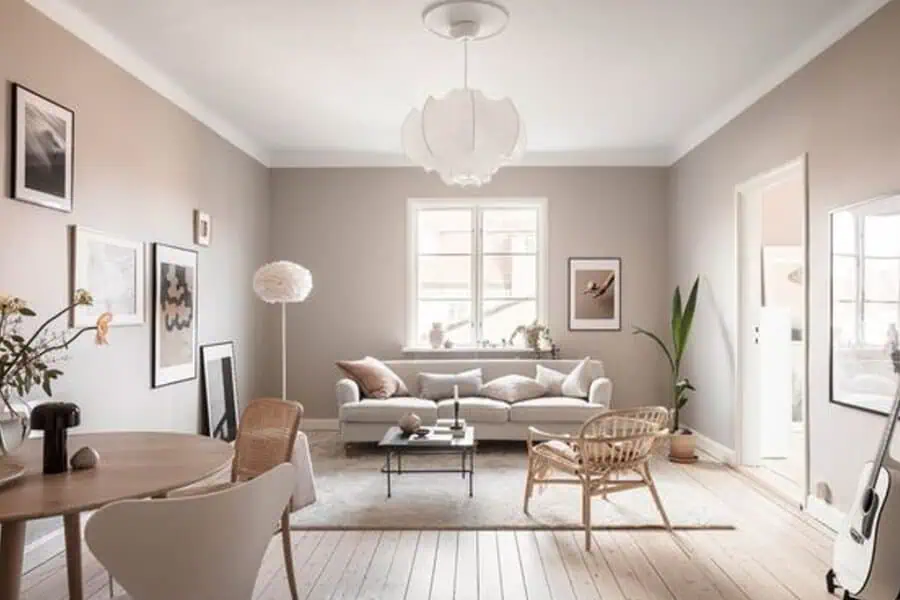 Scandinavian living room with neutral tones, light wood flooring, and modern minimalist decor.