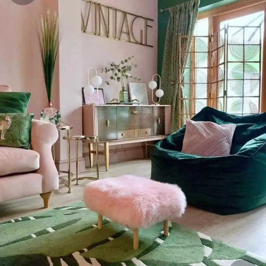 Vintage-inspired living room with pink and green accents, fluffy ottoman, and modern decor.