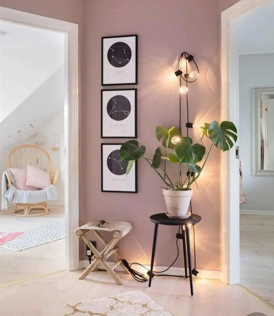 Cozy hallway corner with constellation wall art, potted plant, and soft lighting accents.