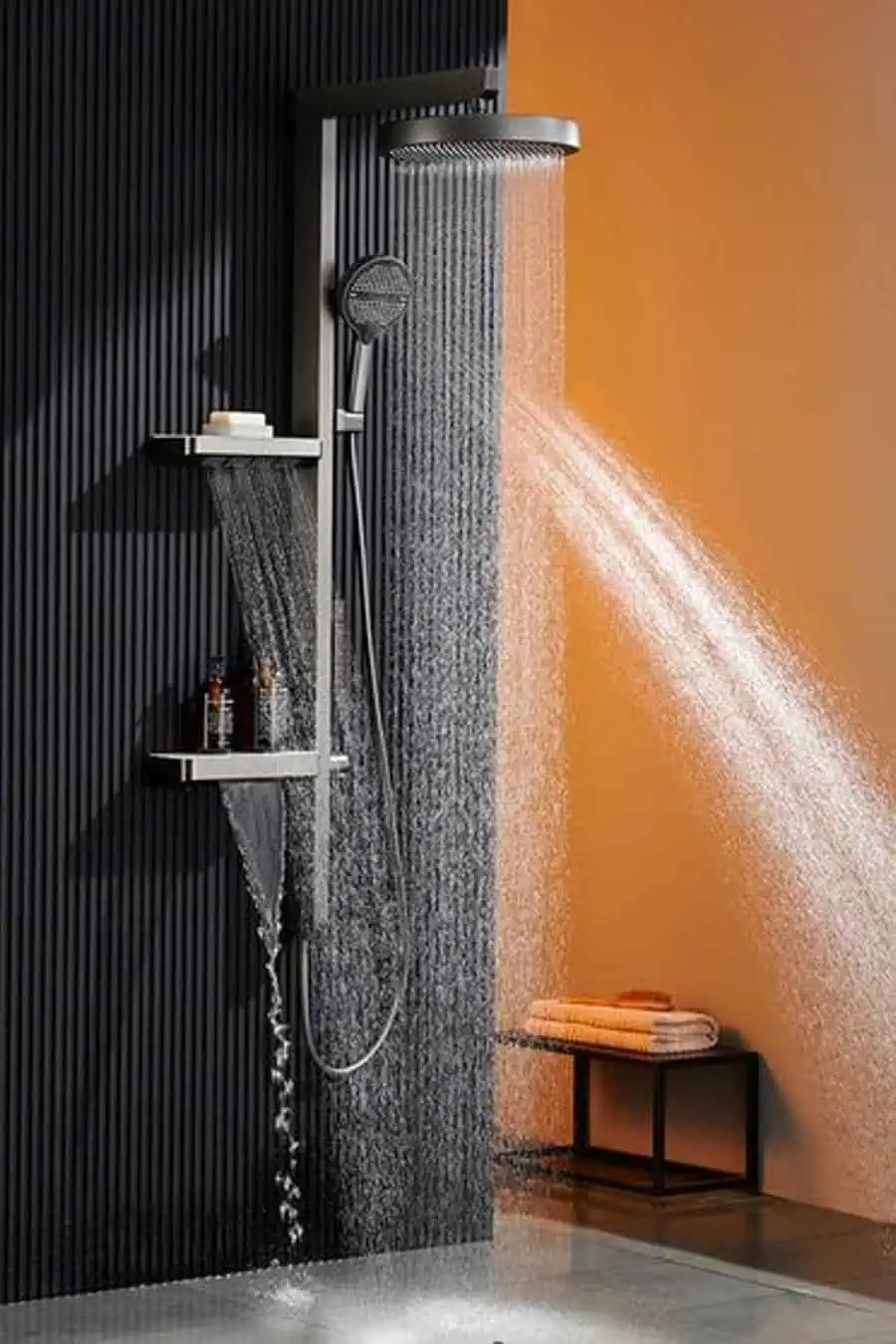 Contemporary shower with rainfall head, black accent wall, and orange backdrop for contrast.