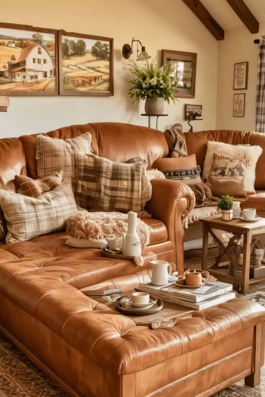 Cozy living room with tan leather sectional, plaid pillows, and farmhouse-themed wall art.