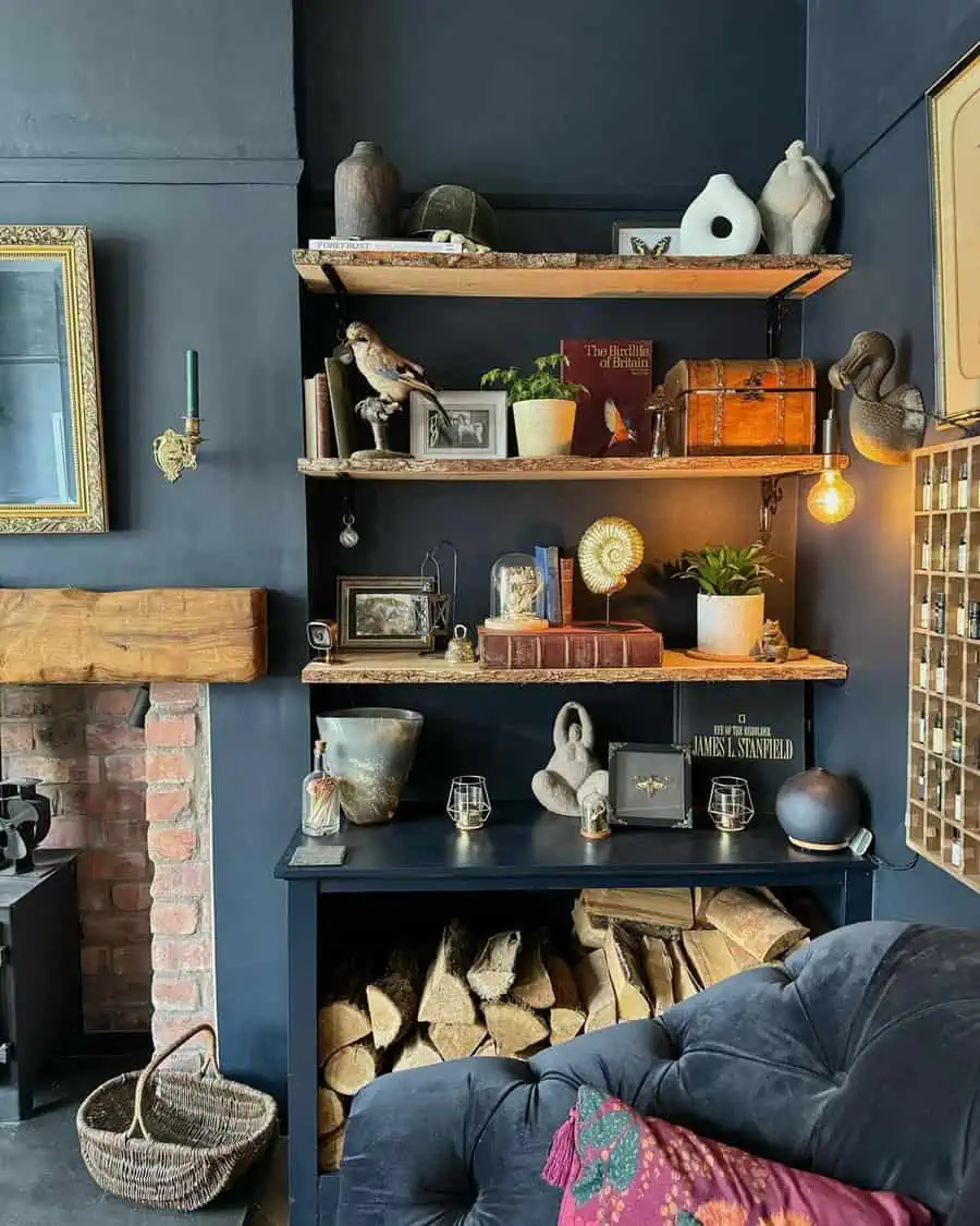 A cozy shelf display featuring books, vintage decor, potted plants, and a taxidermy bird. Below, firewood is stacked neatly, adding warmth to the room's rustic aesthetic.