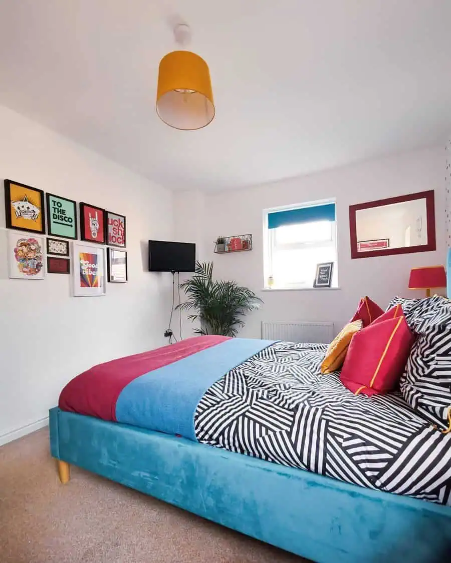 Colorful bedroom with an eclectic gallery wall, bold bedding, and modern decor elements.