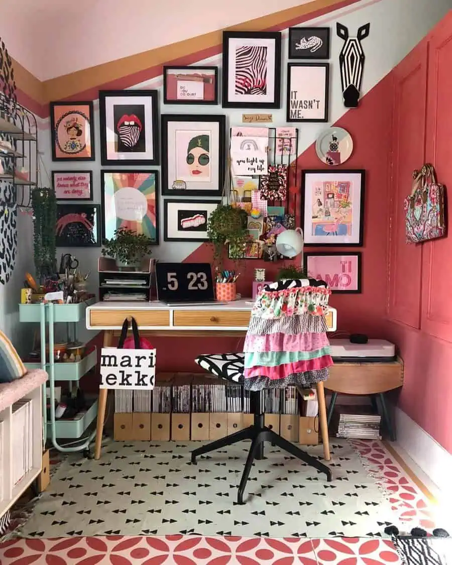 Colorful gallery wall above a small desk in a creative workspace with quirky decor.