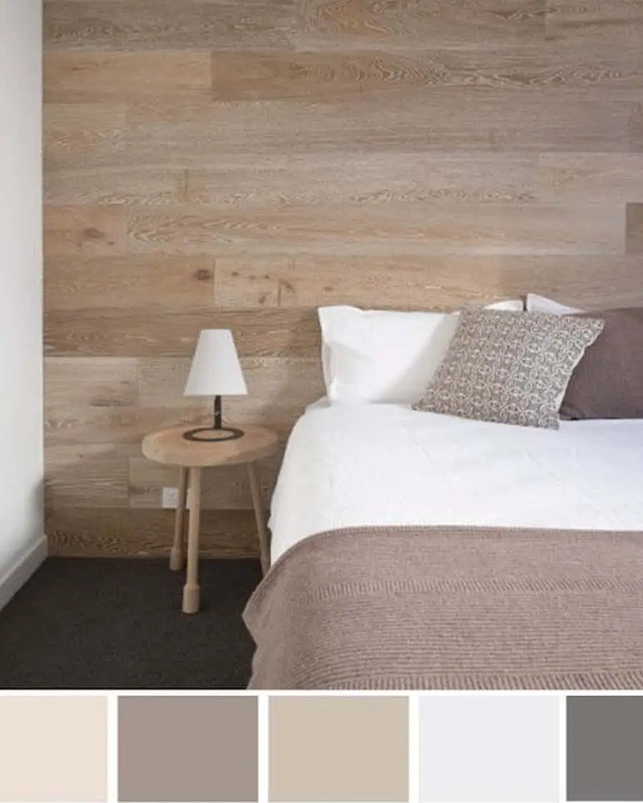 Cozy bedroom with wooden accent wall, neutral bedding, side table, and warm color swatches.