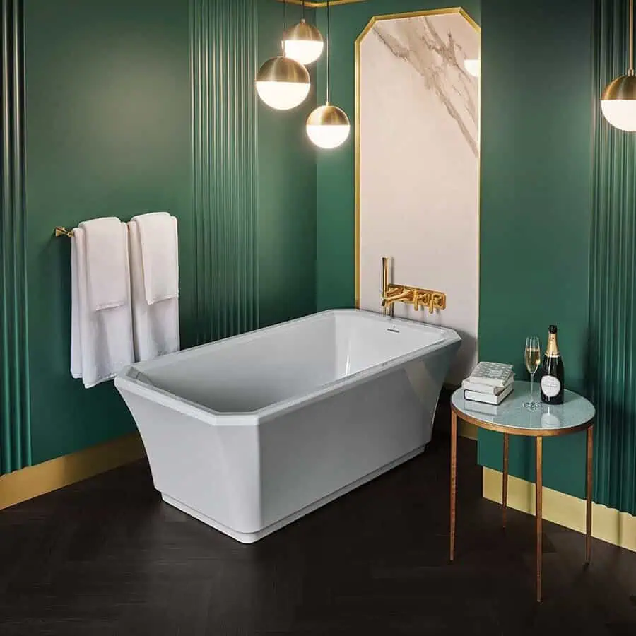 Minimalist Art Deco bathroom with emerald green walls, geometric tub, and gold accents.