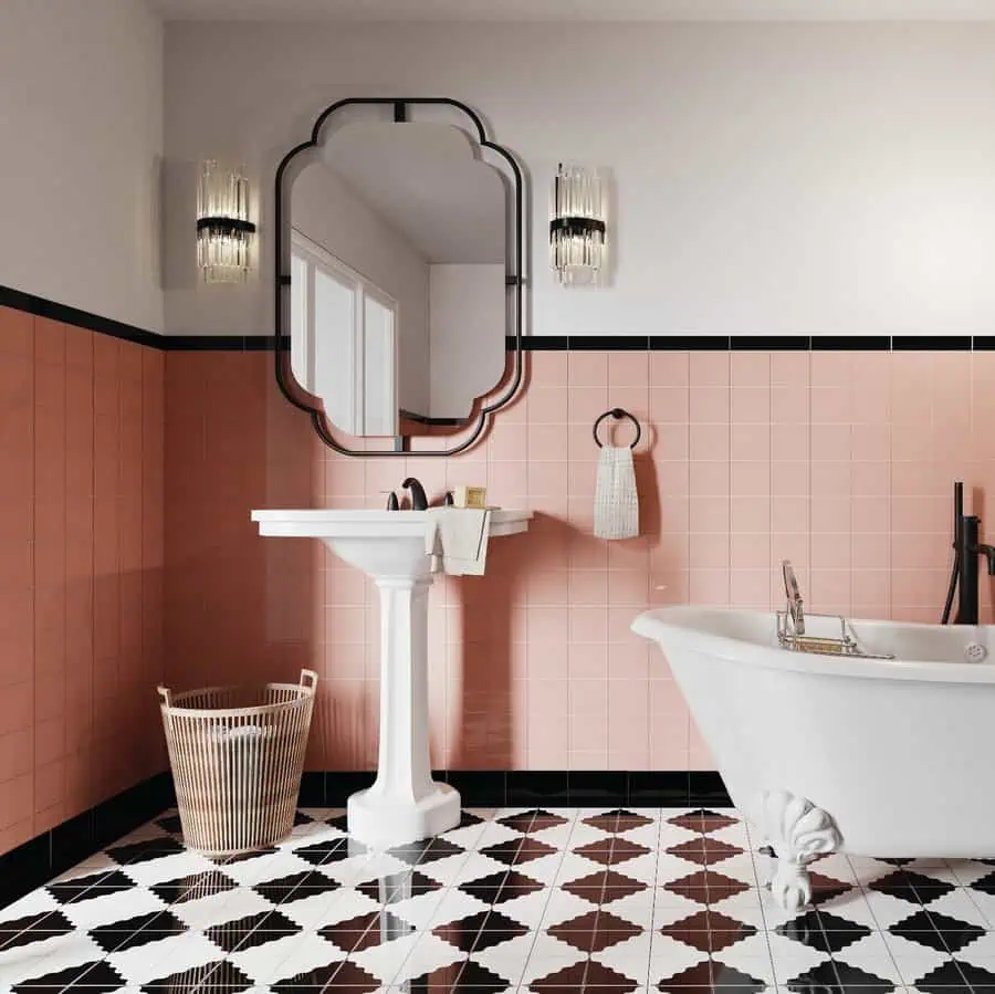 Art Deco bathroom with pink tiles, pedestal sink, clawfoot tub, and geometric flooring.