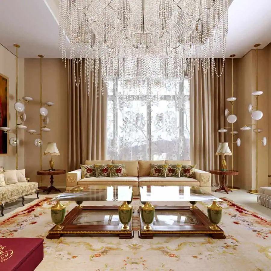 Luxurious living room with a grand crystal chandelier, elegant furniture, and ornate decor.