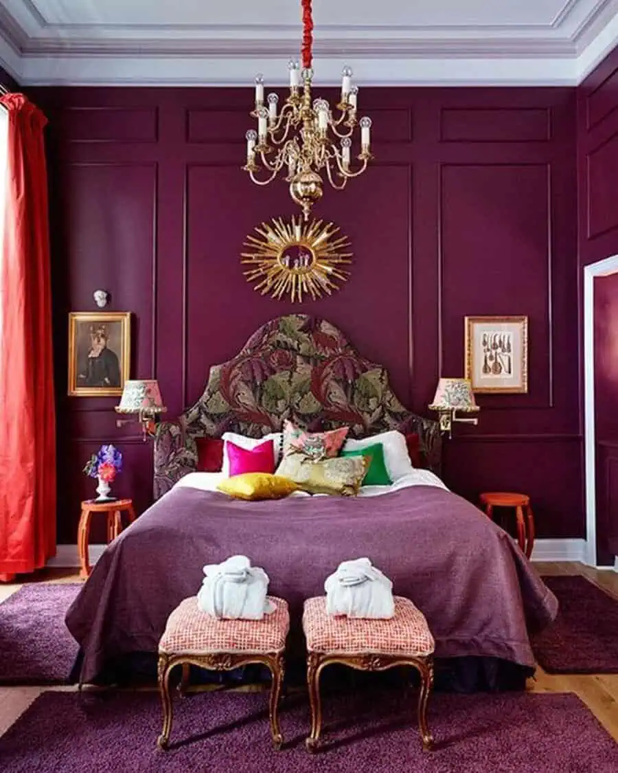 Luxurious bedroom with a bold purple color scheme, ornate chandelier, and patterned headboard.