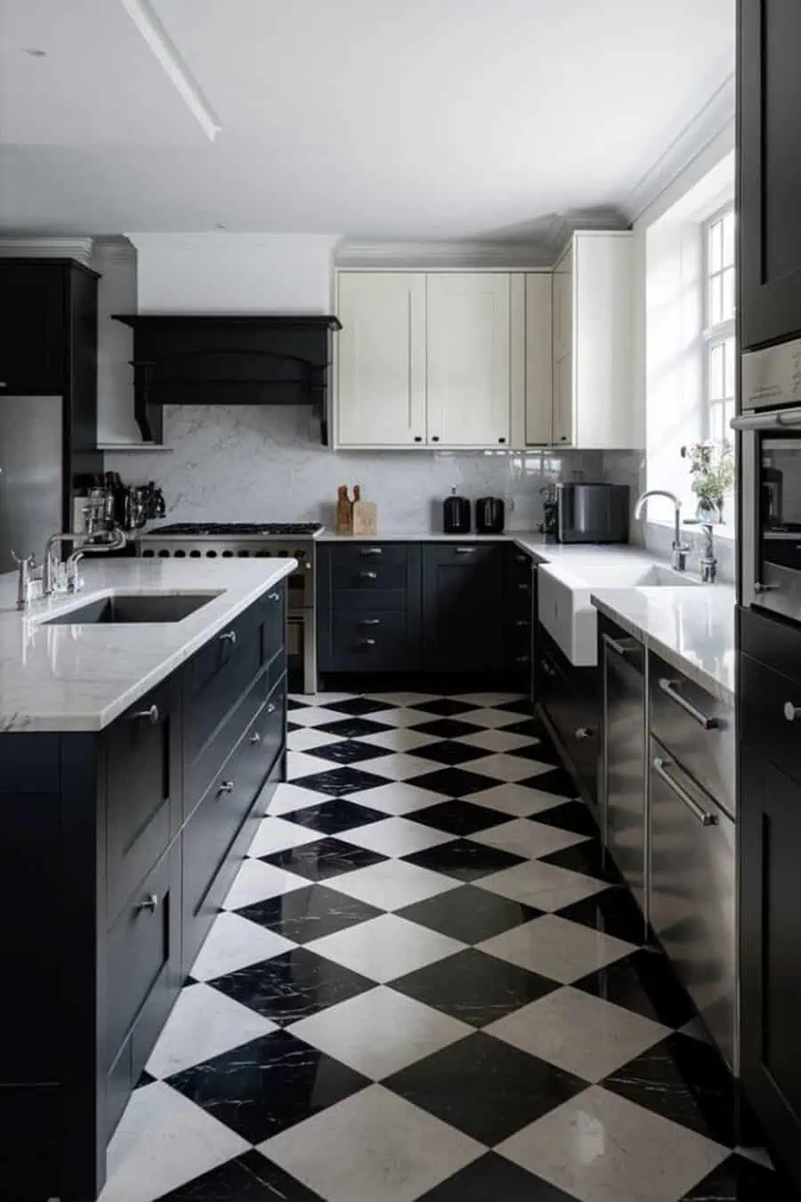 Modern kitchen with dark cabinets, marble countertops, and black-and-white diamond-patterned flooring.