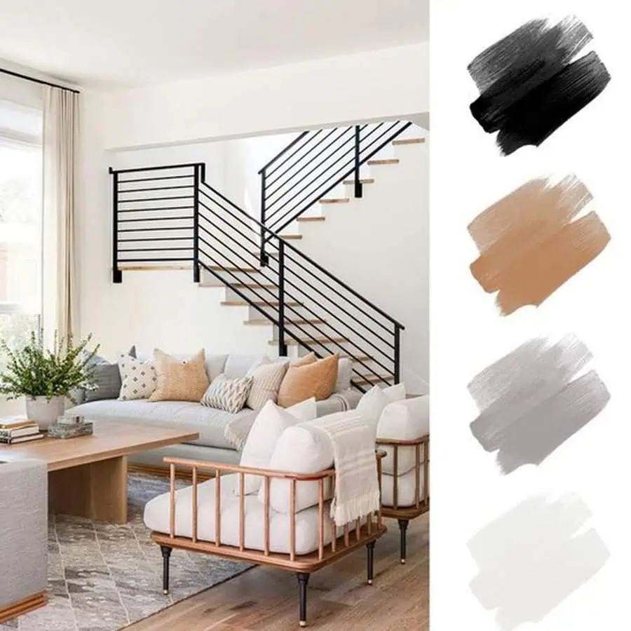 Modern living room with neutral furniture, black stair railing, and complementary color palette.