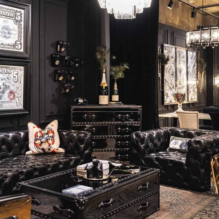 Luxury black leather couches with plush throw pillows and elegant decor accents in a glamorous setting.