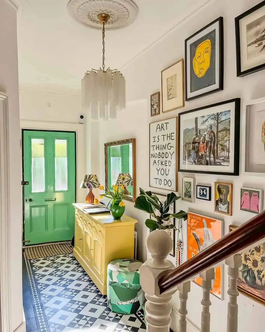 A vibrant entryway with a colorful gallery wall, mint-green door, yellow sideboard, and bold patterned floor creates a lively, eclectic atmosphere.