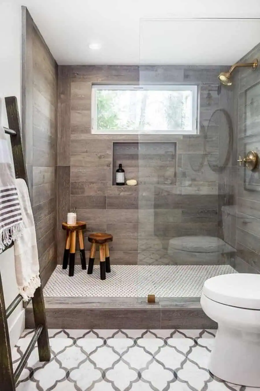 Walk-in shower with wood-look tiles, brass fixtures, penny tile floor, rustic wooden stools, and vanity designs that maximize space.