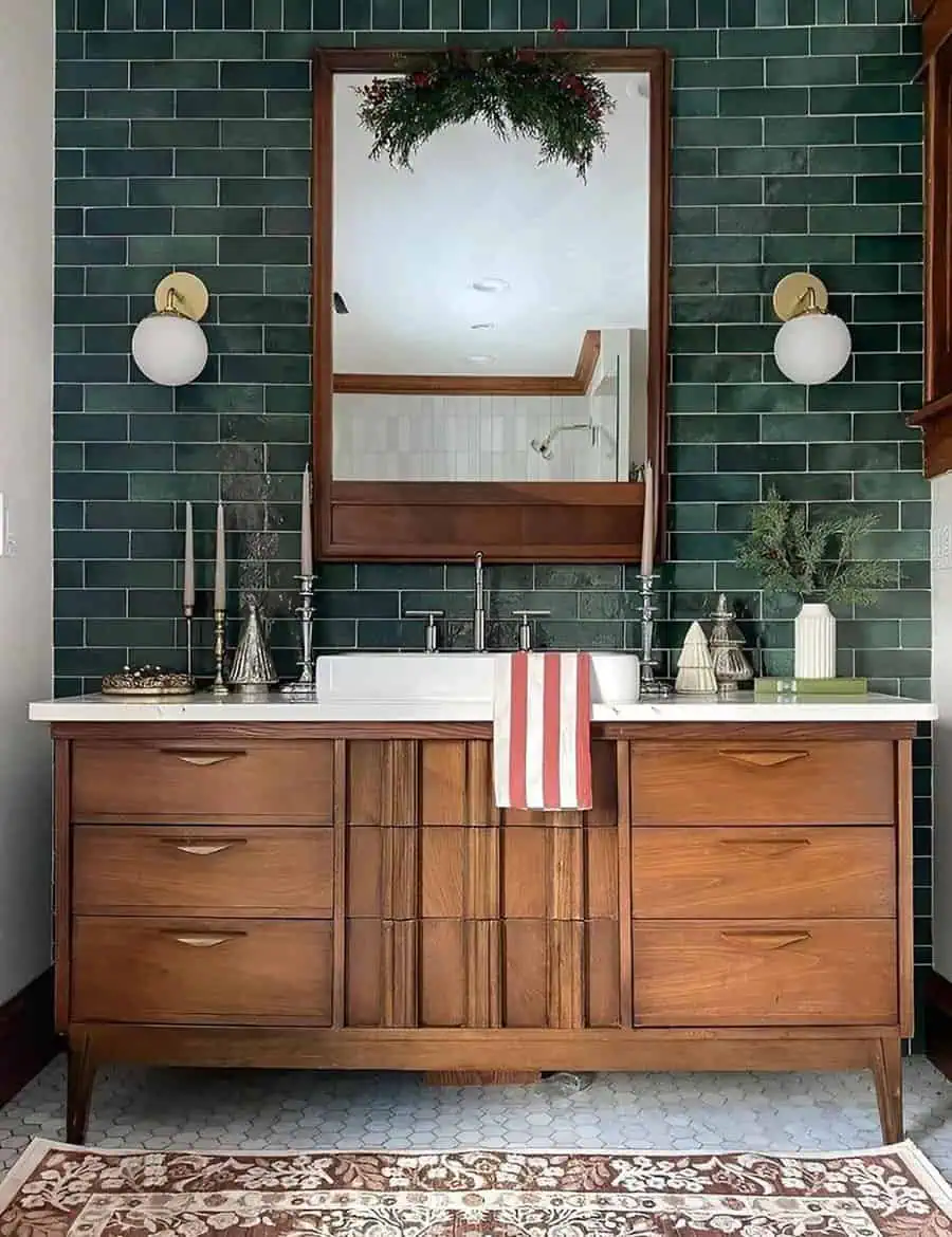 Mid-century style Art Deco bathroom with wooden vanity, green subway tiles, and round wall sconces.