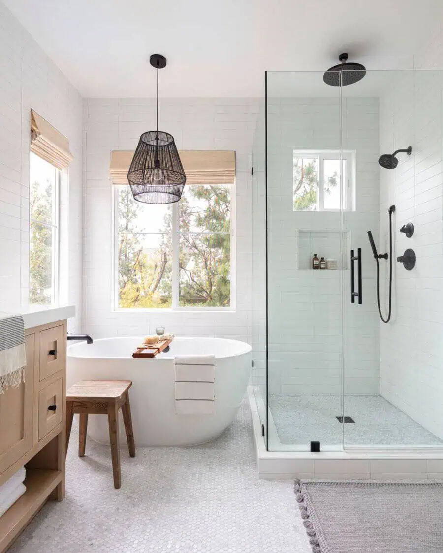 Modern bathroom with a stylish walk-in shower, black fixtures, freestanding tub, and natural light.